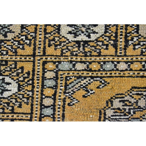 38 - Pakistan rug of Turkoman design with two rows of gols on a beige ground with borders, 153cms x 94cms