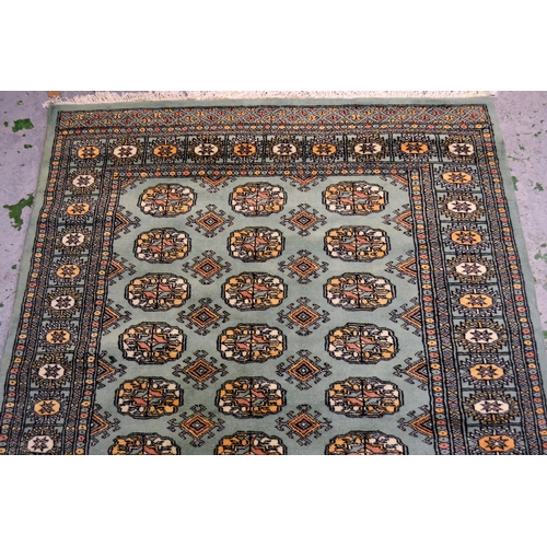 40 - Pakistan rug of Turkoman design with three rows of gols on a green ground with borders, 187cms x 122... 