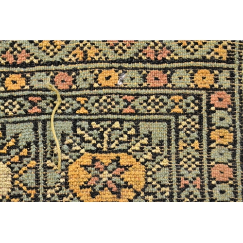 40 - Pakistan rug of Turkoman design with three rows of gols on a green ground with borders, 187cms x 122... 