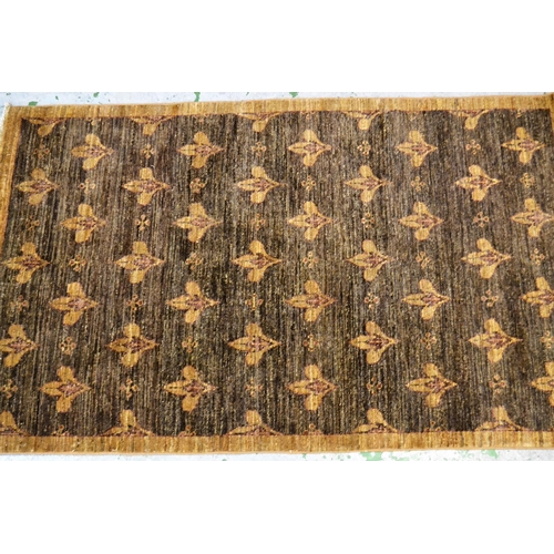 41 - Small Afghan rug with an all-over fleur de lis design in shades of tan, 174cms x 106cms