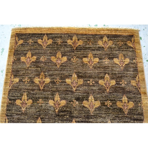 41 - Small Afghan rug with an all-over fleur de lis design in shades of tan, 174cms x 106cms