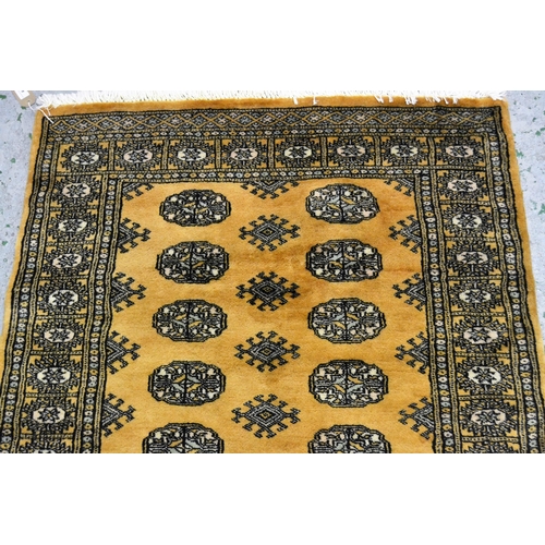 43 - Pakistan rug of Turkoman design with two rows of gols on a beige ground, 153cms x 90cms