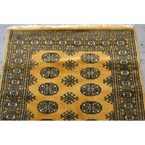 43 - Pakistan rug of Turkoman design with two rows of gols on a beige ground, 153cms x 90cms