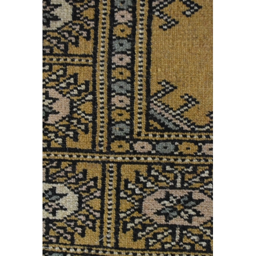 43 - Pakistan rug of Turkoman design with two rows of gols on a beige ground, 153cms x 90cms