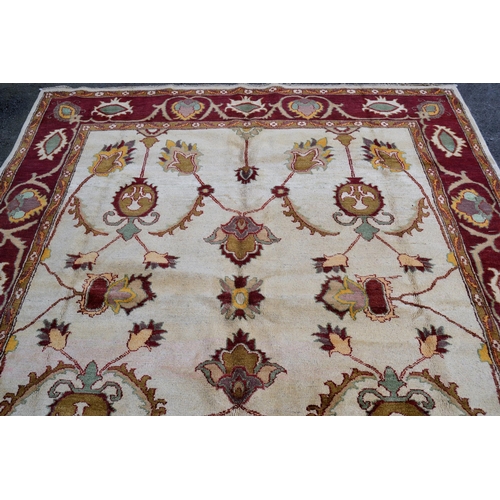 48 - Afghan carpet of Ziegler design with an all-over palmette pattern on an ivory ground with red ground... 