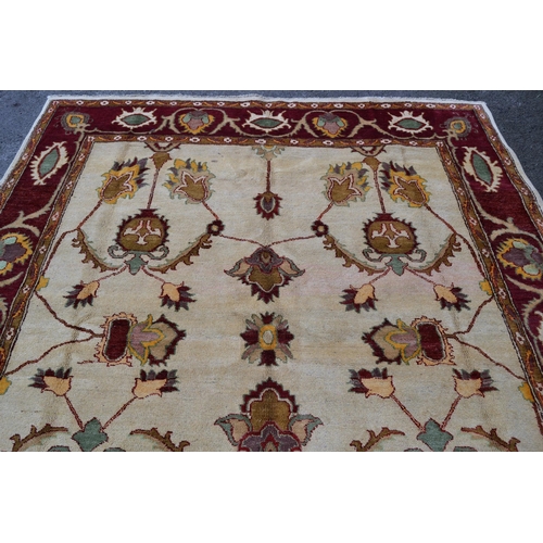 48 - Afghan carpet of Ziegler design with an all-over palmette pattern on an ivory ground with red ground... 