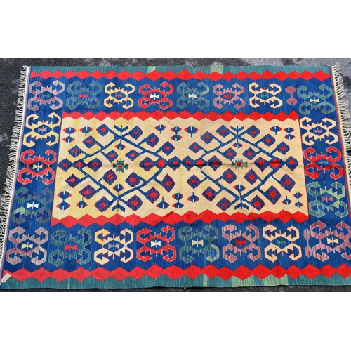 50 - Turkish Kelim rug with a beige ground centre floral panel and blue ground border with hooked motifs,... 