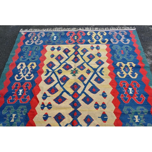 50 - Turkish Kelim rug with a beige ground centre floral panel and blue ground border with hooked motifs,... 