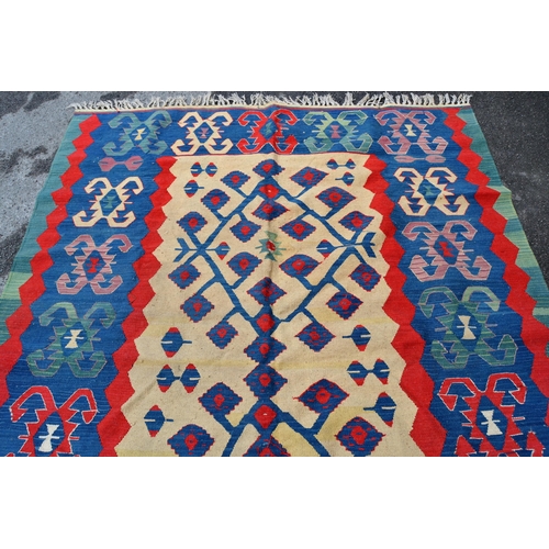 50 - Turkish Kelim rug with a beige ground centre floral panel and blue ground border with hooked motifs,... 