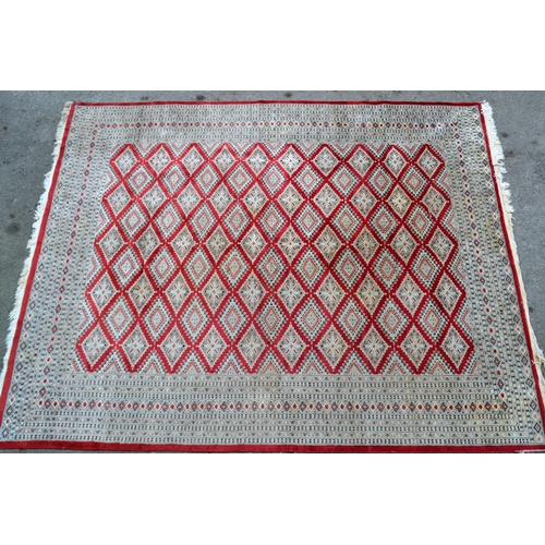 53 - Pakistan carpet of Turkoman design, with an all-over geometric pattern on a red ground with borders ... 