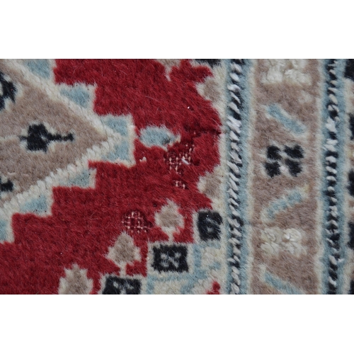 53 - Pakistan carpet of Turkoman design, with an all-over geometric pattern on a red ground with borders ... 