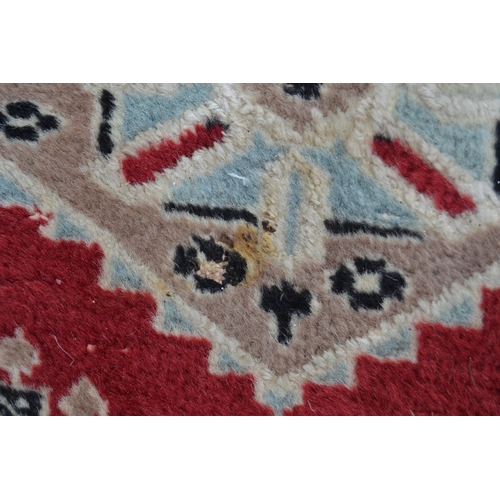 53 - Pakistan carpet of Turkoman design, with an all-over geometric pattern on a red ground with borders ... 