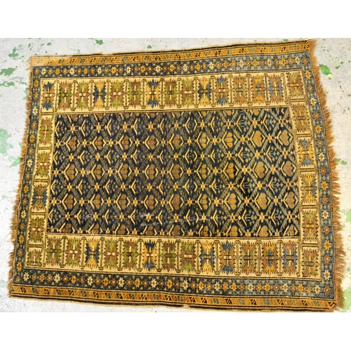 55 - Small Shirvan rug, the center panel with an all-over stylised floral design on blue ground, an ivory... 