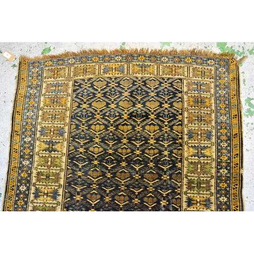 55 - Small Shirvan rug, the center panel with an all-over stylised floral design on blue ground, an ivory... 