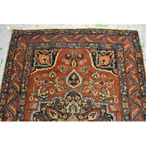 56 - Small Meshed rug with a medallion and floral design on a red ground with borders, 169cms x 110cms ap... 