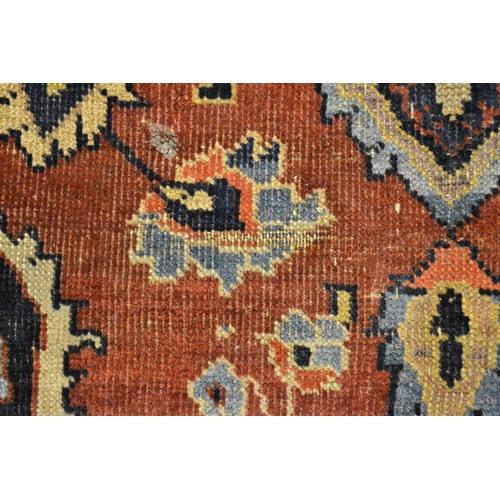 56 - Small Meshed rug with a medallion and floral design on a red ground with borders, 169cms x 110cms ap... 