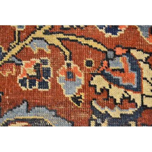 56 - Small Meshed rug with a medallion and floral design on a red ground with borders, 169cms x 110cms ap... 