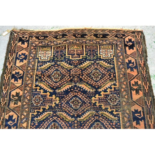 57 - Belouch rug with an all-over hooked medallion design on a midnight blue ground with borders, (slight... 