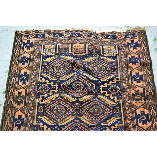 57 - Belouch rug with an all-over hooked medallion design on a midnight blue ground with borders, (slight... 