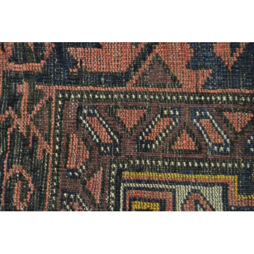 57 - Belouch rug with an all-over hooked medallion design on a midnight blue ground with borders, (slight... 