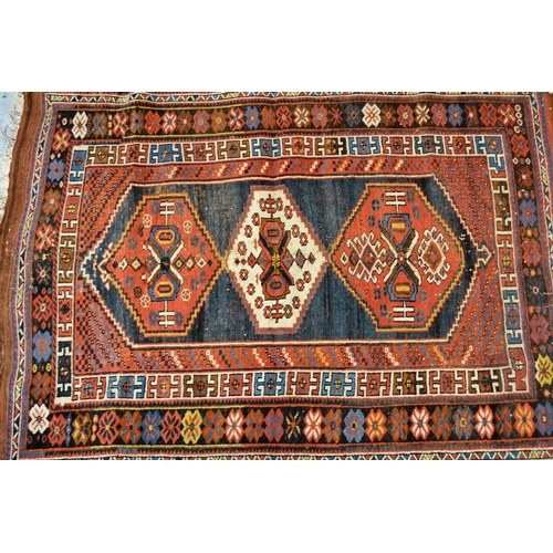 58 - Kazak rug with a triple medallion design on a blue ground with multiple borders, 170cms x 120cms app... 