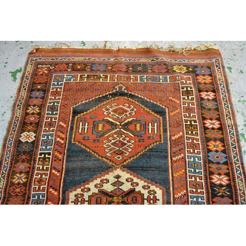 58 - Kazak rug with a triple medallion design on a blue ground with multiple borders, 170cms x 120cms app... 