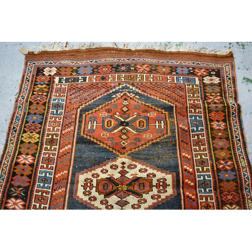 58 - Kazak rug with a triple medallion design on a blue ground with multiple borders, 170cms x 120cms app... 