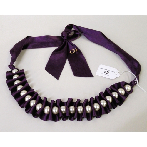 82 - Carolina Herrera, purple ribbon necklace with simulated pearl decoration