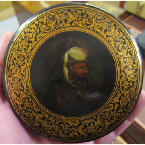 247 - 19th Century circular papier mache snuff box, the cover painted with portrait of a Turk