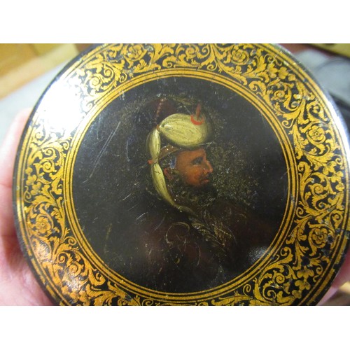 247 - 19th Century circular papier mache snuff box, the cover painted with portrait of a Turk