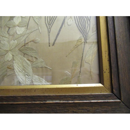 76 - Pair of Japanese silk embroidered pictures, birds in foliage, 47cms x 36cms, oak framed