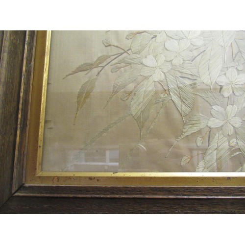 76 - Pair of Japanese silk embroidered pictures, birds in foliage, 47cms x 36cms, oak framed