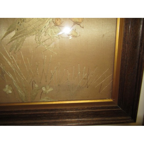 76 - Pair of Japanese silk embroidered pictures, birds in foliage, 47cms x 36cms, oak framed