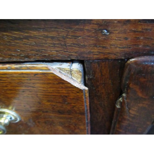 1605 - 18th Century oak dresser base, a moulded plank top above an arrangement of seven drawers with brass ... 