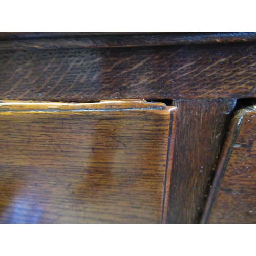 1605 - 18th Century oak dresser base, a moulded plank top above an arrangement of seven drawers with brass ... 