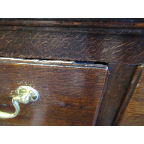 1605 - 18th Century oak dresser base, a moulded plank top above an arrangement of seven drawers with brass ... 