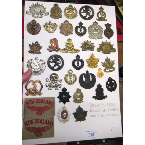 180 - Two cards mounted with various Australian, Canadian and New Zealand military badges