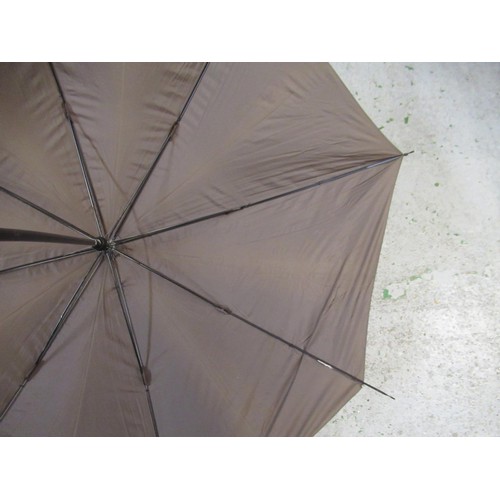 254 - Christian Dior umbrella, together with another umbrella