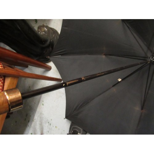 254 - Christian Dior umbrella, together with another umbrella