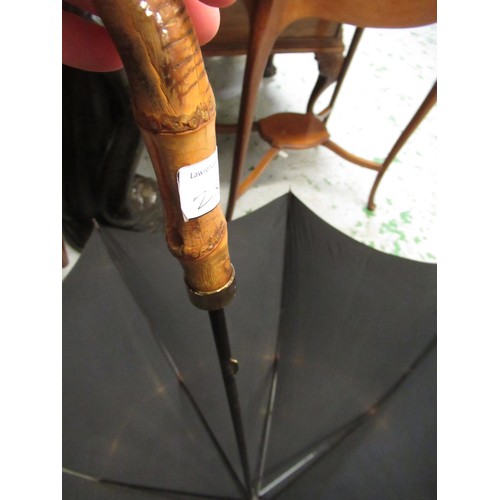 254 - Christian Dior umbrella, together with another umbrella