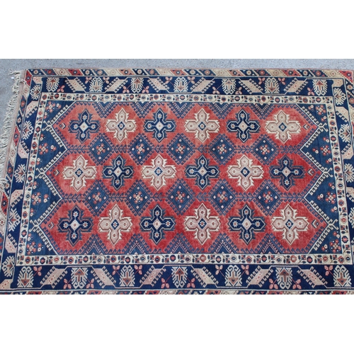 11 - Turkish carpet with an all-over medallion design in shades of blue, rose and cream, 290cms x 201cms