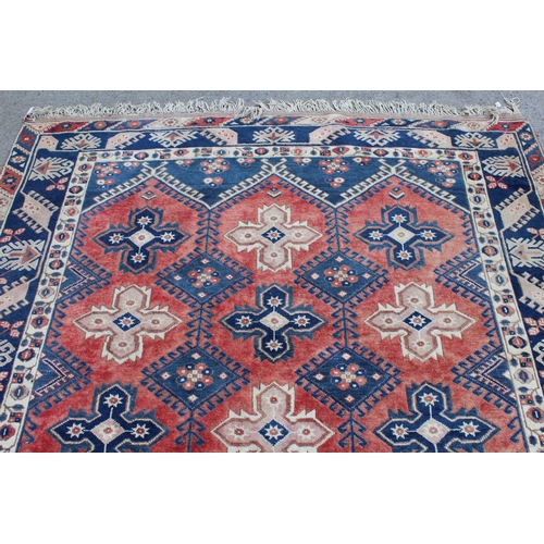 11 - Turkish carpet with an all-over medallion design in shades of blue, rose and cream, 290cms x 201cms