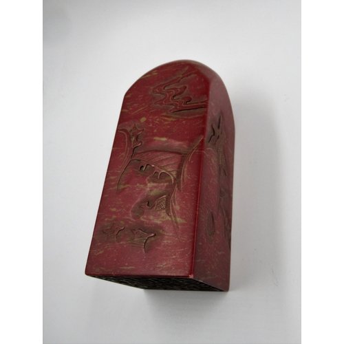 133 - 20th Century Chinese carved red soapstone seal, decorated with landscape scenes, 15cm x 6cm approxim... 