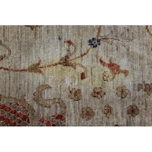 14 - Indo Persian carpet with an all-over flowerhead and vase design on an ivory ground with borders, (so... 