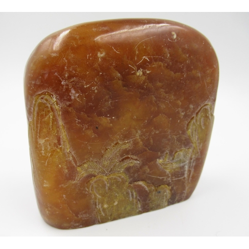 141 - Amber coloured soapstone carving decorated in shallow relief with figures and landscape, double side... 