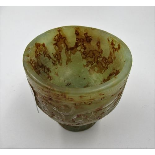 149 - 20th Century carved mottled green/rust jade stem cup, decorated in shallow relief, 5.5cm high