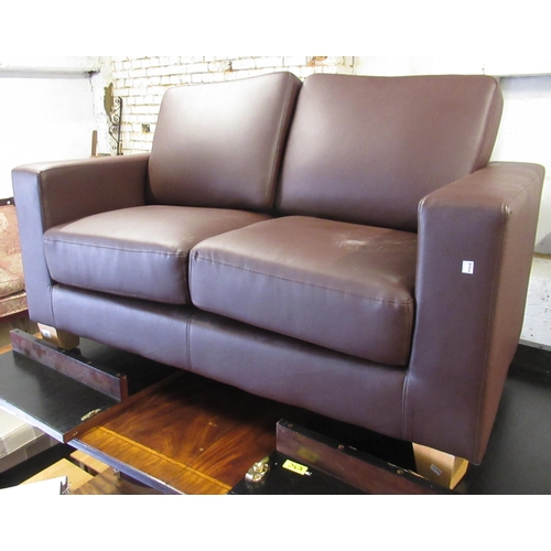 1549 - Small dark tan simulated leather two seat sofa or rectangular design, 135cms wide