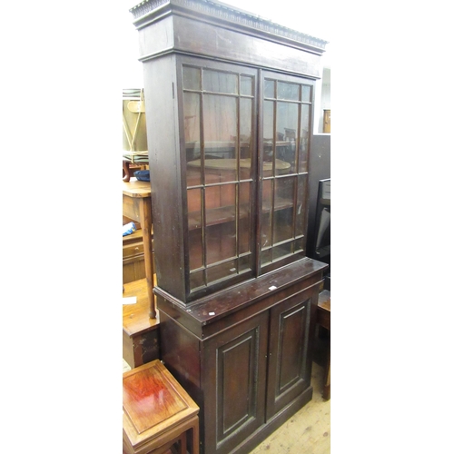 1552 - 19th Century mahogany bookcase, the moulded and carved cornice above two bar glazed doors enclosing ... 