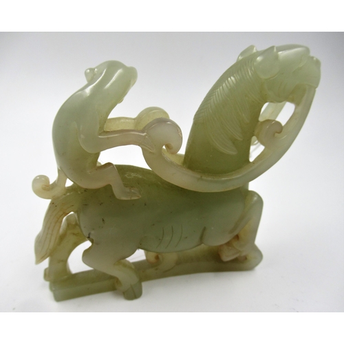 156 - Carved pale green jade group of a monkey riding a horse, 8.5cm x 9cm approximately