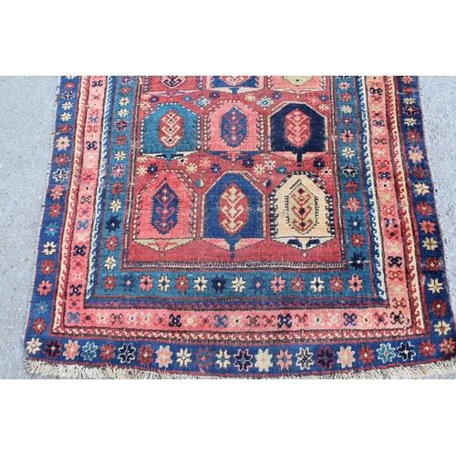 18 - Kazak runner with an all-over stylised design on a brick red ground with borders, 250cms x 108cms ap... 